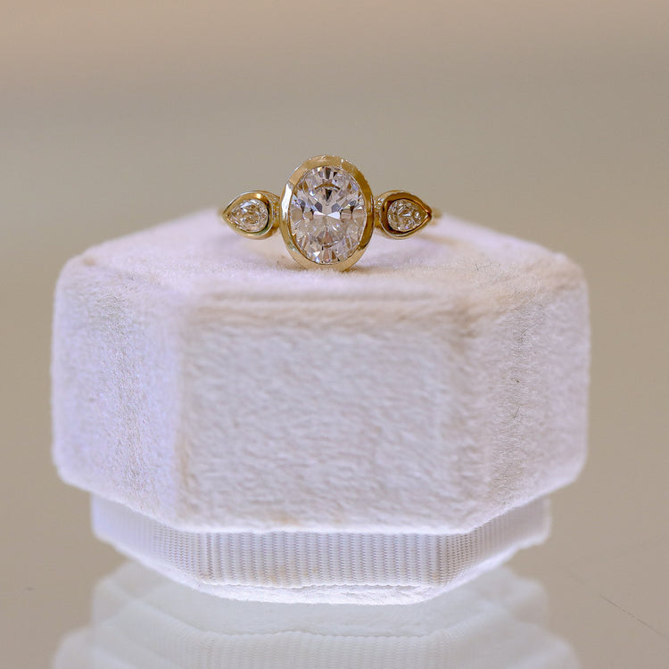 14ky Three Stone Bezel Oval & .41ctw Pear-Shaped Lab Diamond Ring
