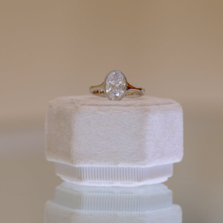 Platinum Oval-Cut Bezel Tapered Cathedral Diamond Ring