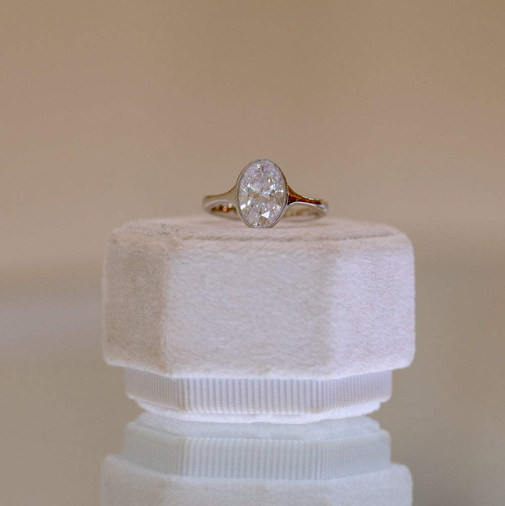 Platinum Oval-Cut Bezel Tapered Cathedral Diamond Ring